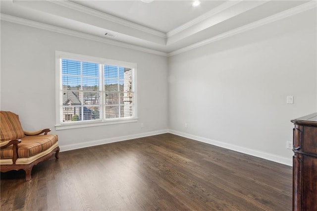 unfurnished room featuring a tray ceiling, dark wood finished floors, visible vents, and baseboards