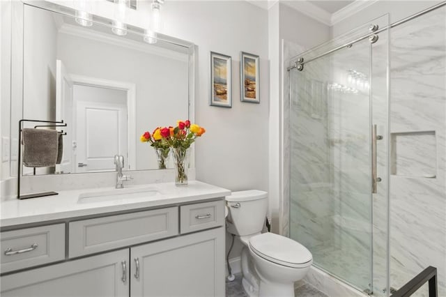 bathroom with a marble finish shower, ornamental molding, vanity, and toilet