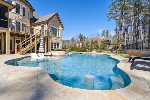 pool featuring a patio area, stairway, and a deck