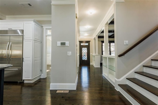 unfurnished living room with ceiling fan, beam ceiling, dark wood-type flooring, coffered ceiling, and ornate columns