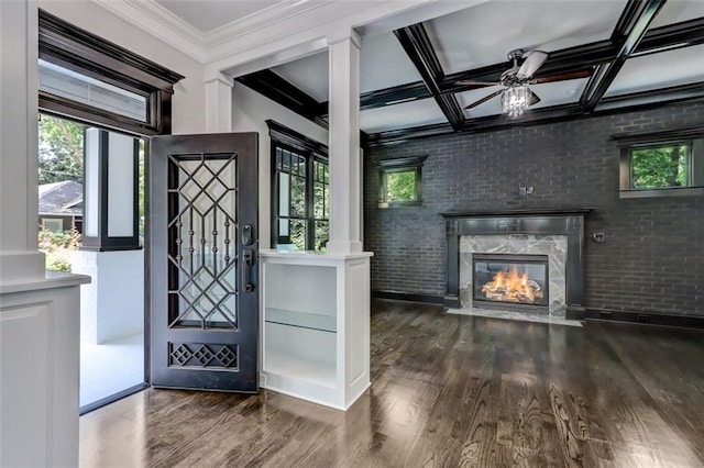 kitchen with wall chimney exhaust hood, white cabinetry, light stone counters, and high quality appliances