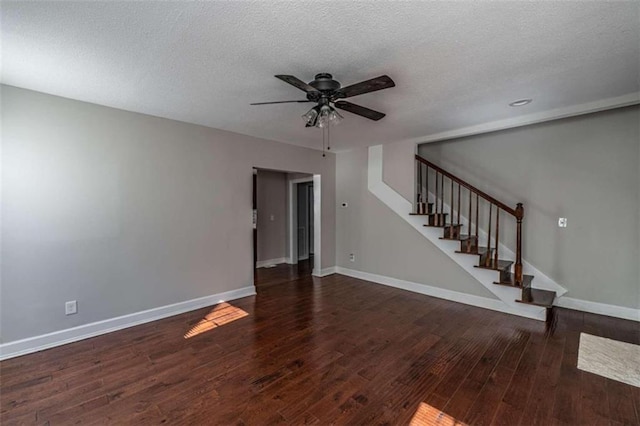 unfurnished living room featuring ceiling fan, a textured ceiling, and dark hardwood / wood-style flooring