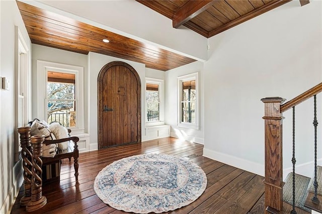 foyer with stairs, dark wood-style floors, wood ceiling, and baseboards