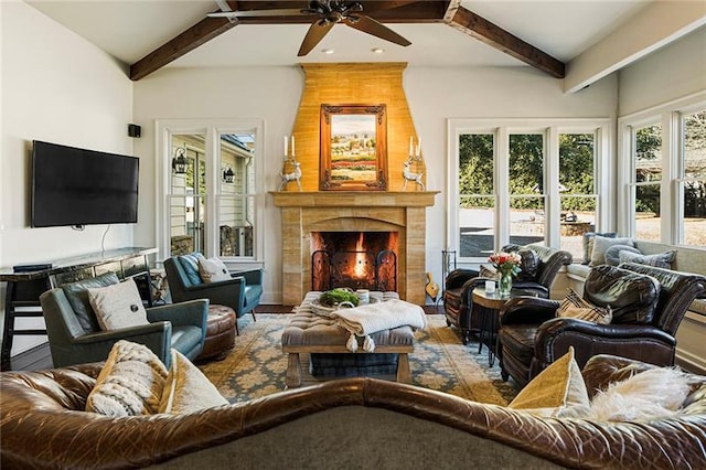 living room featuring beam ceiling and a fireplace