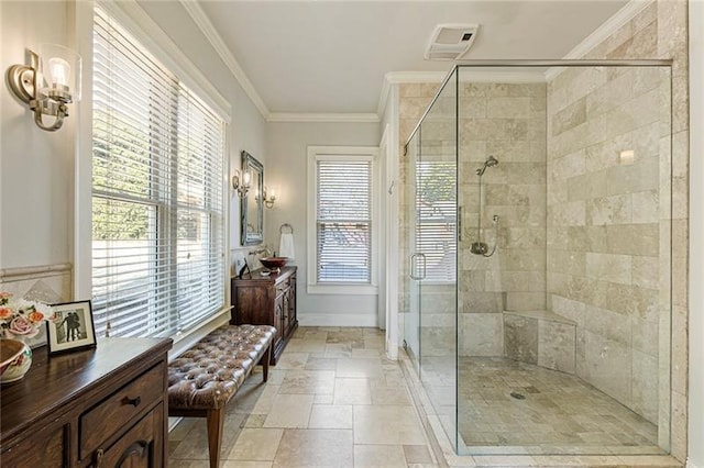 full bathroom with vanity, baseboards, visible vents, a shower stall, and crown molding