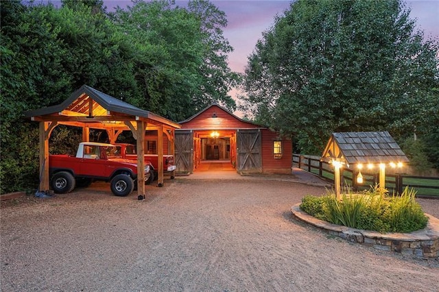 view of front of property with an outbuilding and gravel driveway