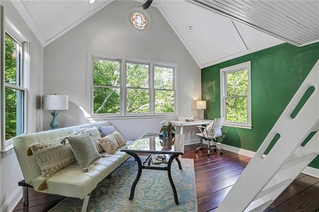 living room featuring vaulted ceiling, baseboards, and hardwood / wood-style flooring