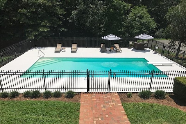 view of pool with a fenced in pool, fence, and a patio area