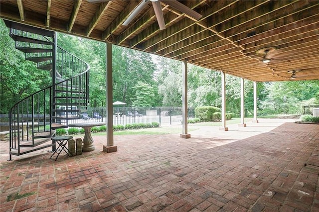 view of patio featuring stairway and fence