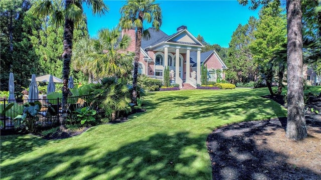 view of front of home with a front yard and covered porch