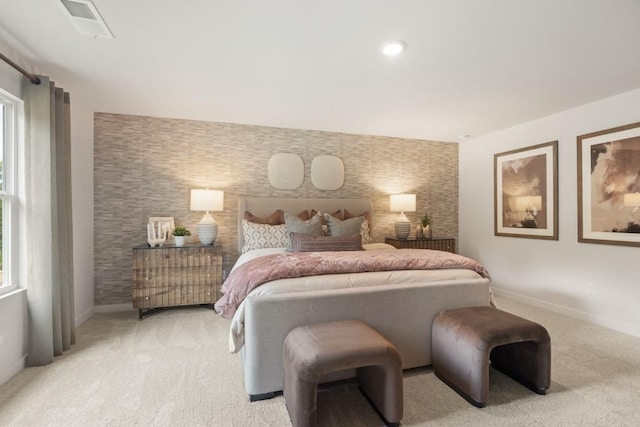 carpeted bedroom featuring recessed lighting, an accent wall, visible vents, baseboards, and wallpapered walls