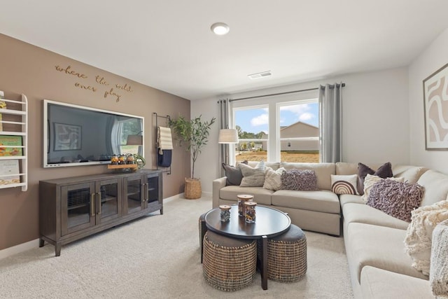 carpeted living area with visible vents and baseboards