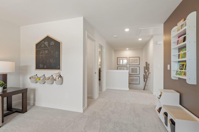 hall with carpet floors, recessed lighting, baseboards, and an upstairs landing