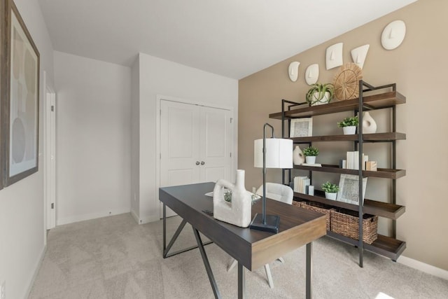 home office featuring light colored carpet and baseboards