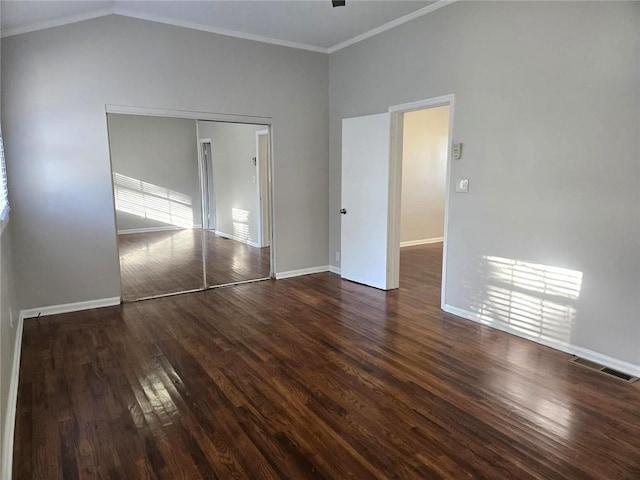 unfurnished bedroom featuring visible vents, ornamental molding, baseboards, and wood finished floors