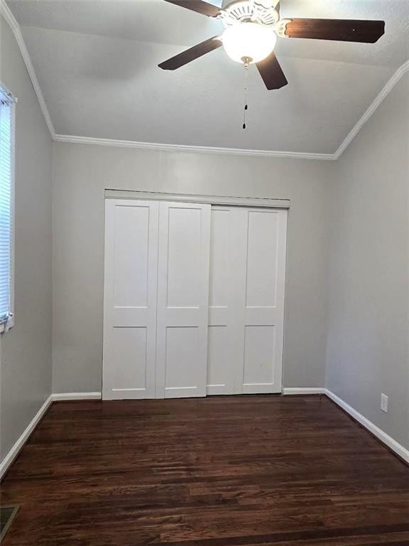 unfurnished bedroom featuring baseboards, wood finished floors, and crown molding