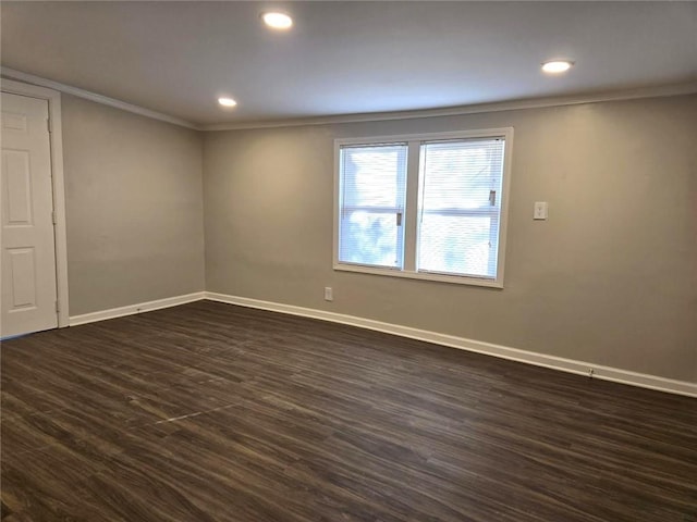 spare room with recessed lighting, crown molding, baseboards, and dark wood-style flooring