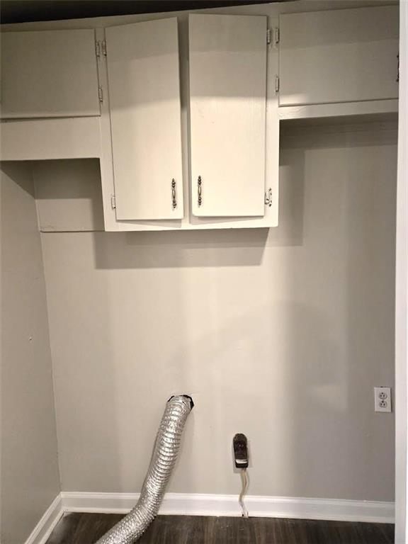 laundry area featuring baseboards, cabinet space, hookup for an electric dryer, and wood finished floors