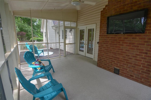 sunroom / solarium with french doors, lofted ceiling, and a ceiling fan