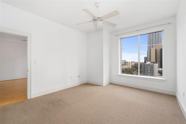 carpeted empty room featuring ceiling fan