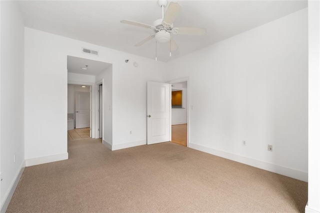 unfurnished bedroom with ceiling fan and light colored carpet