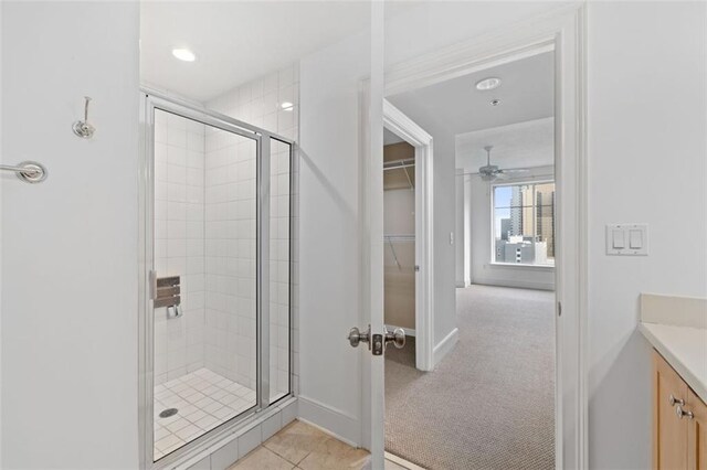 bathroom with vanity, an enclosed shower, and ceiling fan