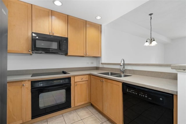 kitchen with pendant lighting, sink, light tile patterned floors, black appliances, and an inviting chandelier