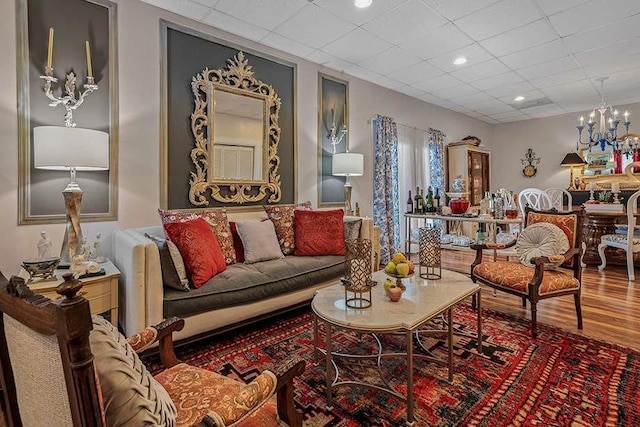 living room with hardwood / wood-style flooring and an inviting chandelier