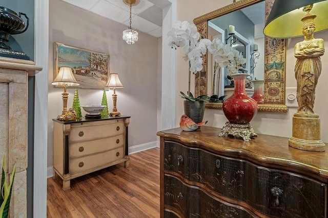 hallway featuring a chandelier and hardwood / wood-style flooring