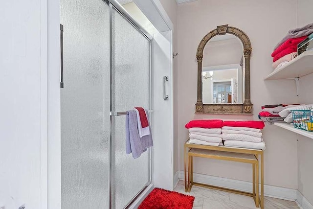 bathroom featuring an enclosed shower and a chandelier