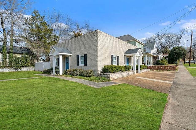 view of side of home with a lawn