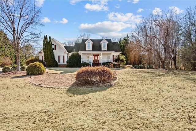 new england style home featuring covered porch