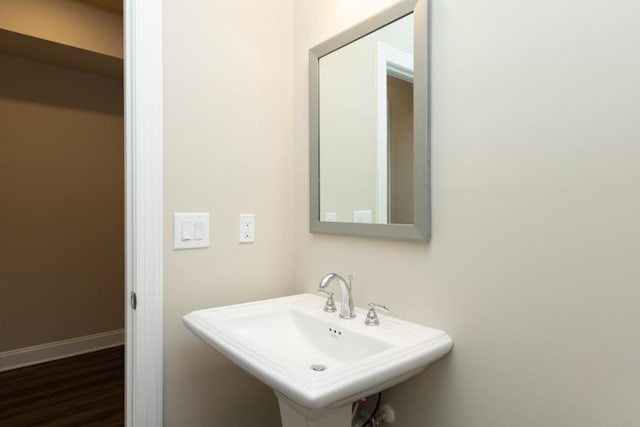 5587 Spring St, Flowery Branch, GA 30542 - bathroom featuring a sink and wood finished floors