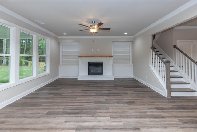 5587 Spring St, Flowery Branch, GA 30542 - unfurnished living room with ceiling fan, a fireplace with raised hearth, baseboards, wood finished floors, and stairway