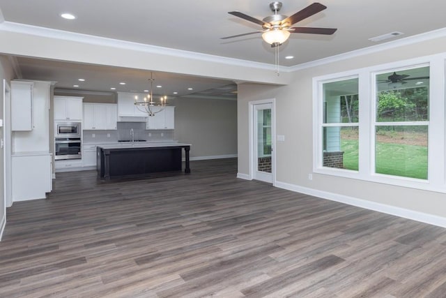5587 Spring St, Flowery Branch, GA 30542 - unfurnished living room featuring visible vents, crown molding, baseboards, a sink, and ceiling fan with notable chandelier