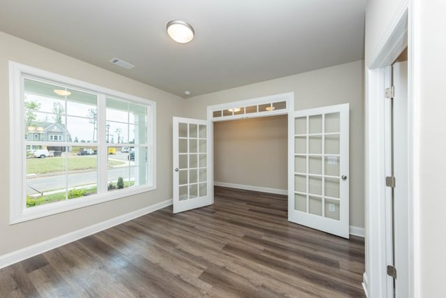 5587 Spring St, Flowery Branch, GA 30542 - spare room featuring french doors, dark wood finished floors, baseboards, and visible vents