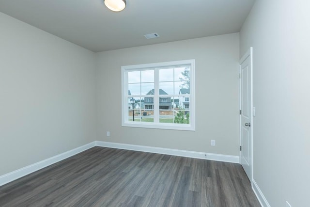 5587 Spring St, Flowery Branch, GA 30542 - unfurnished room featuring visible vents, baseboards, and dark wood-style floors