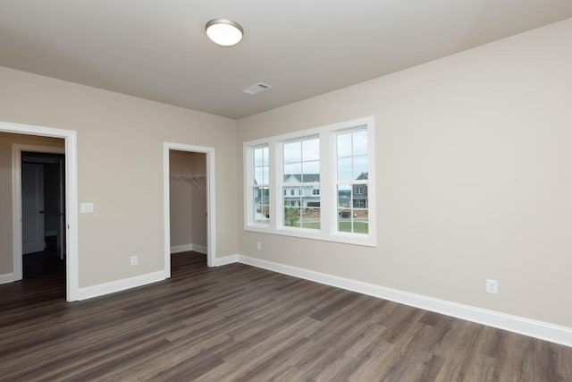 5587 Spring St, Flowery Branch, GA 30542 - unfurnished bedroom with baseboards, a closet, and dark wood-style floors