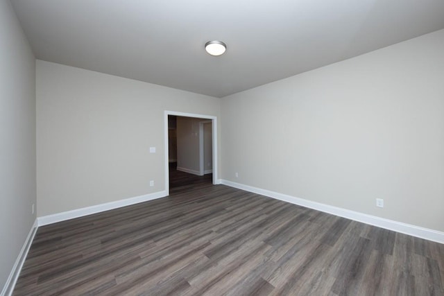 5587 Spring St, Flowery Branch, GA 30542 - unfurnished room with baseboards and dark wood-type flooring