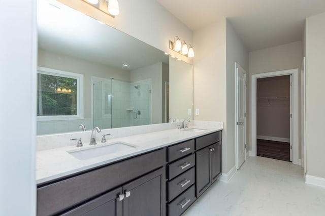 5587 Spring St, Flowery Branch, GA 30542 - full bath with double vanity, a walk in closet, a shower stall, and a sink