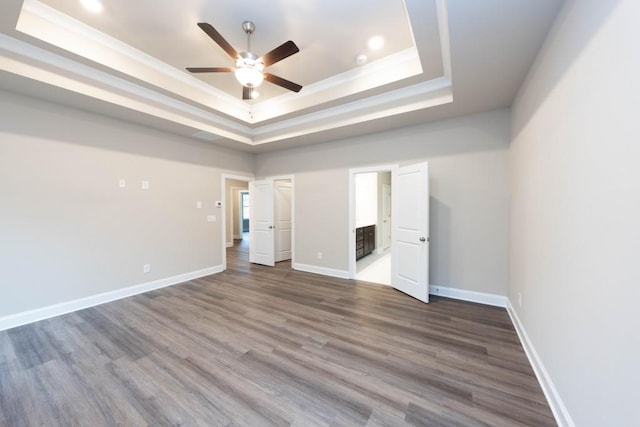 5587 Spring St, Flowery Branch, GA 30542 - unfurnished bedroom featuring recessed lighting, baseboards, a tray ceiling, and dark wood finished floors