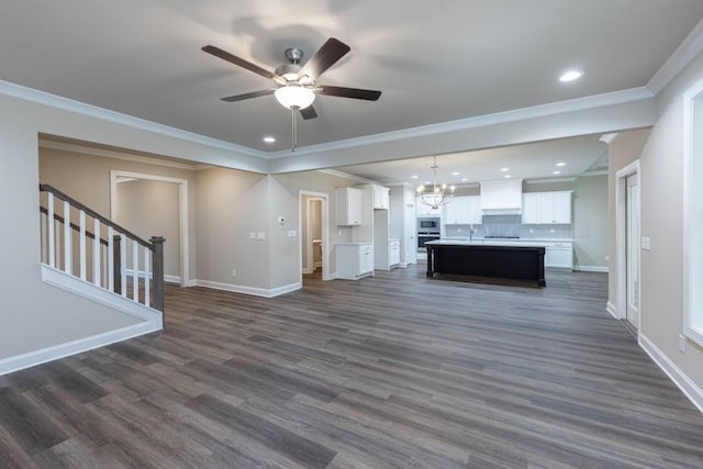 5587 Spring St, Flowery Branch, GA 30542 - unfurnished living room featuring stairs, baseboards, recessed lighting, dark wood-type flooring, and ceiling fan with notable chandelier
