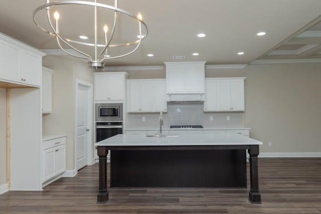 5587 Spring St, Flowery Branch, GA 30542 - kitchen featuring ornamental molding, an island with sink, tasteful backsplash, a sink, and stainless steel appliances