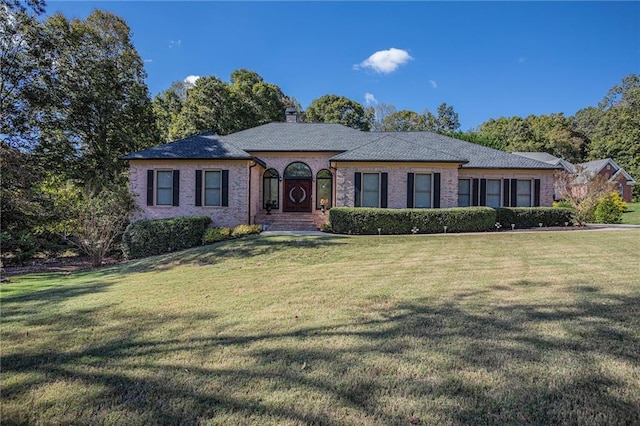 ranch-style home with a front lawn