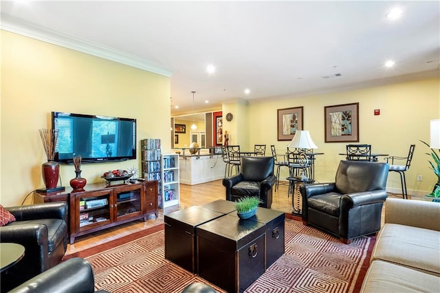 living room featuring hardwood / wood-style flooring and crown molding