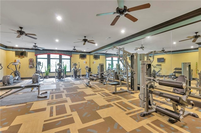 gym with ornamental molding, ceiling fan, and a healthy amount of sunlight