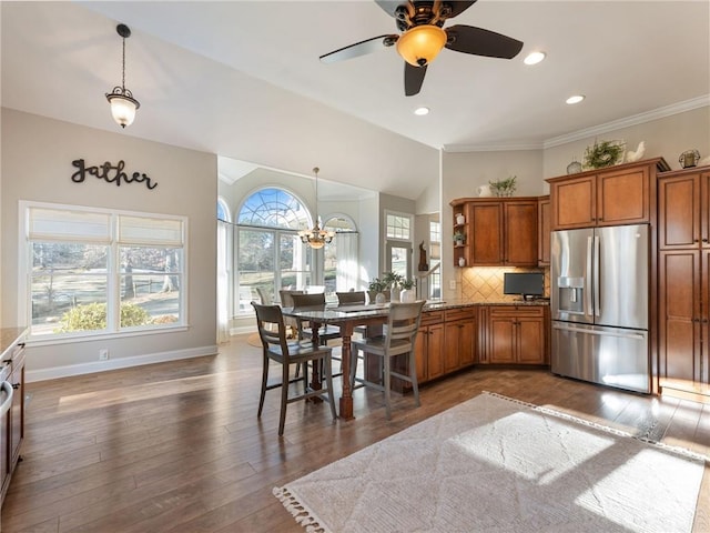 kitchen featuring lofted ceiling, pendant lighting, stainless steel refrigerator with ice dispenser, decorative backsplash, and dark hardwood / wood-style flooring