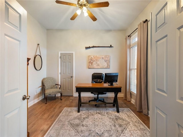 home office featuring ceiling fan and light hardwood / wood-style flooring