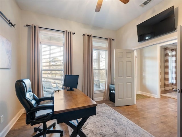 office with ceiling fan and light hardwood / wood-style flooring