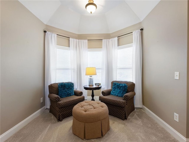 living area featuring vaulted ceiling and light carpet